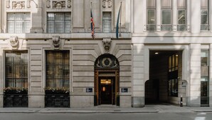A grand building with a symmetrical facade, large windows, and a central entrance with a decorative arch. - Club Quarters Hotel London City, London (London)