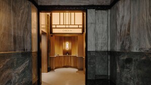 A check-in area with a wooden reception desk and a 'CHECK IN' sign above it. - Club Quarters Hotel London City, London (London)