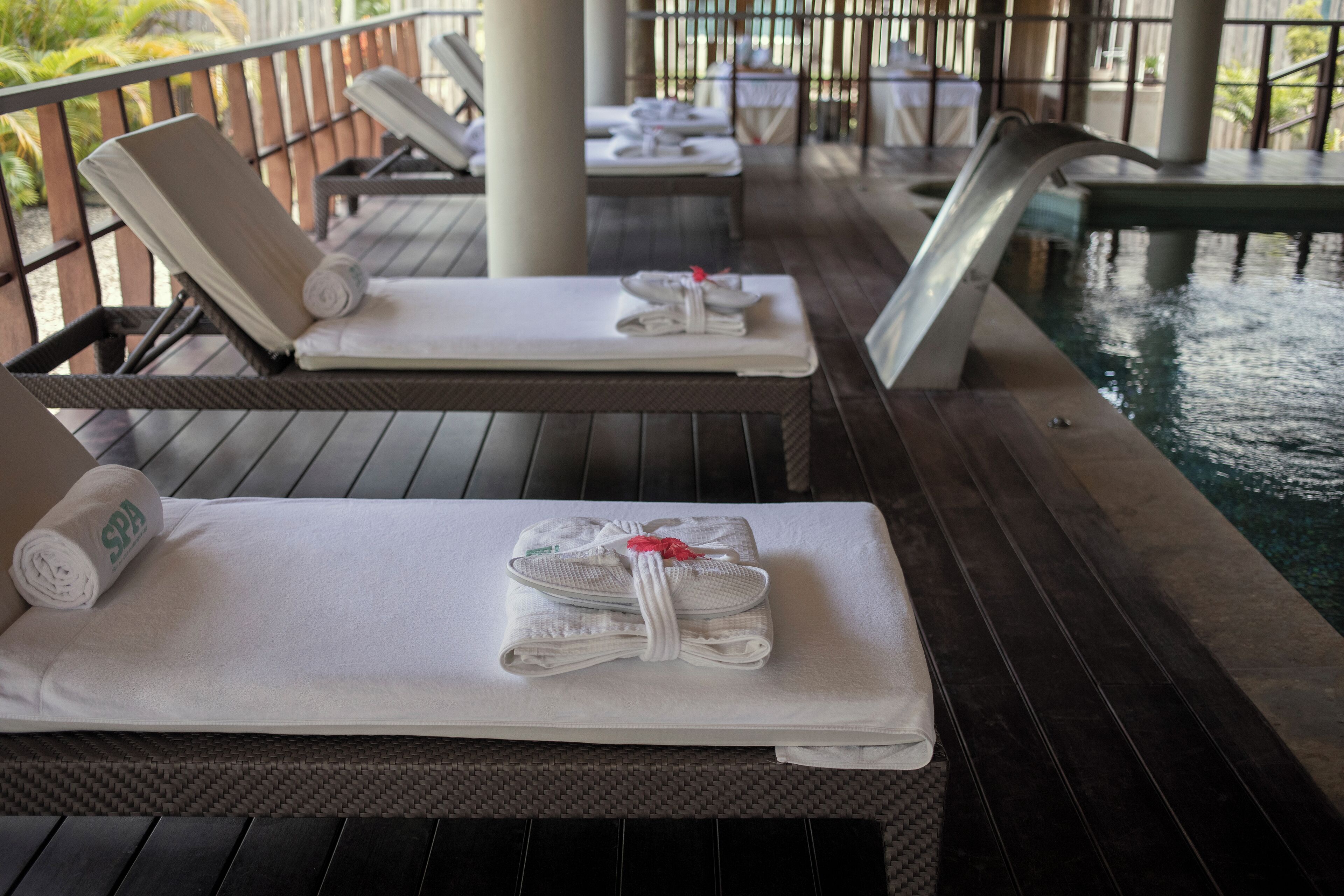 A poolside area with lounge chairs and towels.