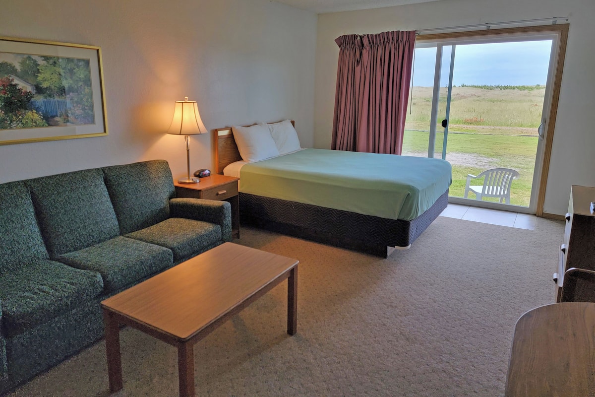 Condo (1st Floor, Dunes View) | Living area | 43-inch flat-screen TV with cable channels, books, video library