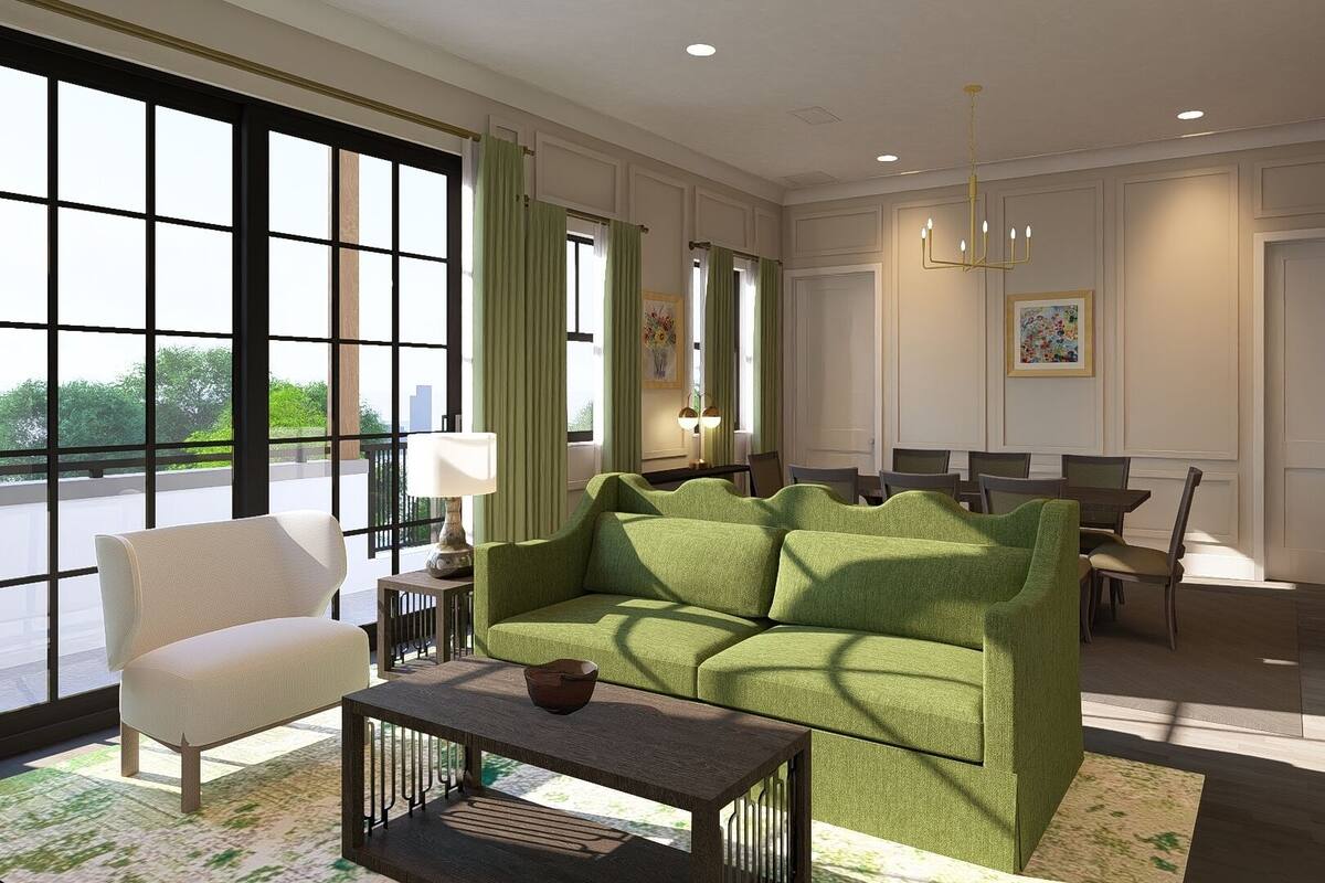 A modern living room with a green sofa, a white armchair, a wooden coffee table, and a dining area with chairs and a table.