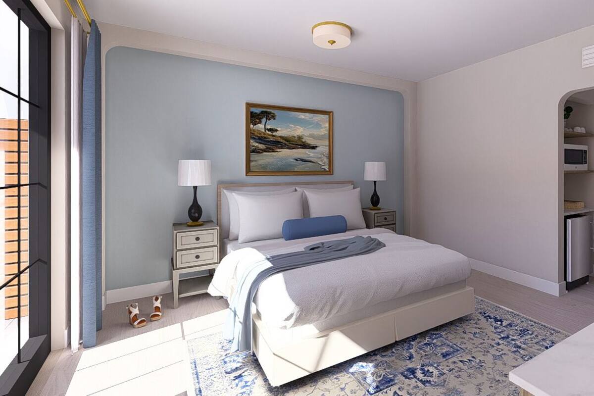 A bedroom with a bed, nightstands, a painting, a desk, and a chair.