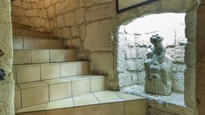 A stone staircase with a statue at the landing.