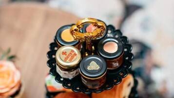 A tray with jars of honey and bread.