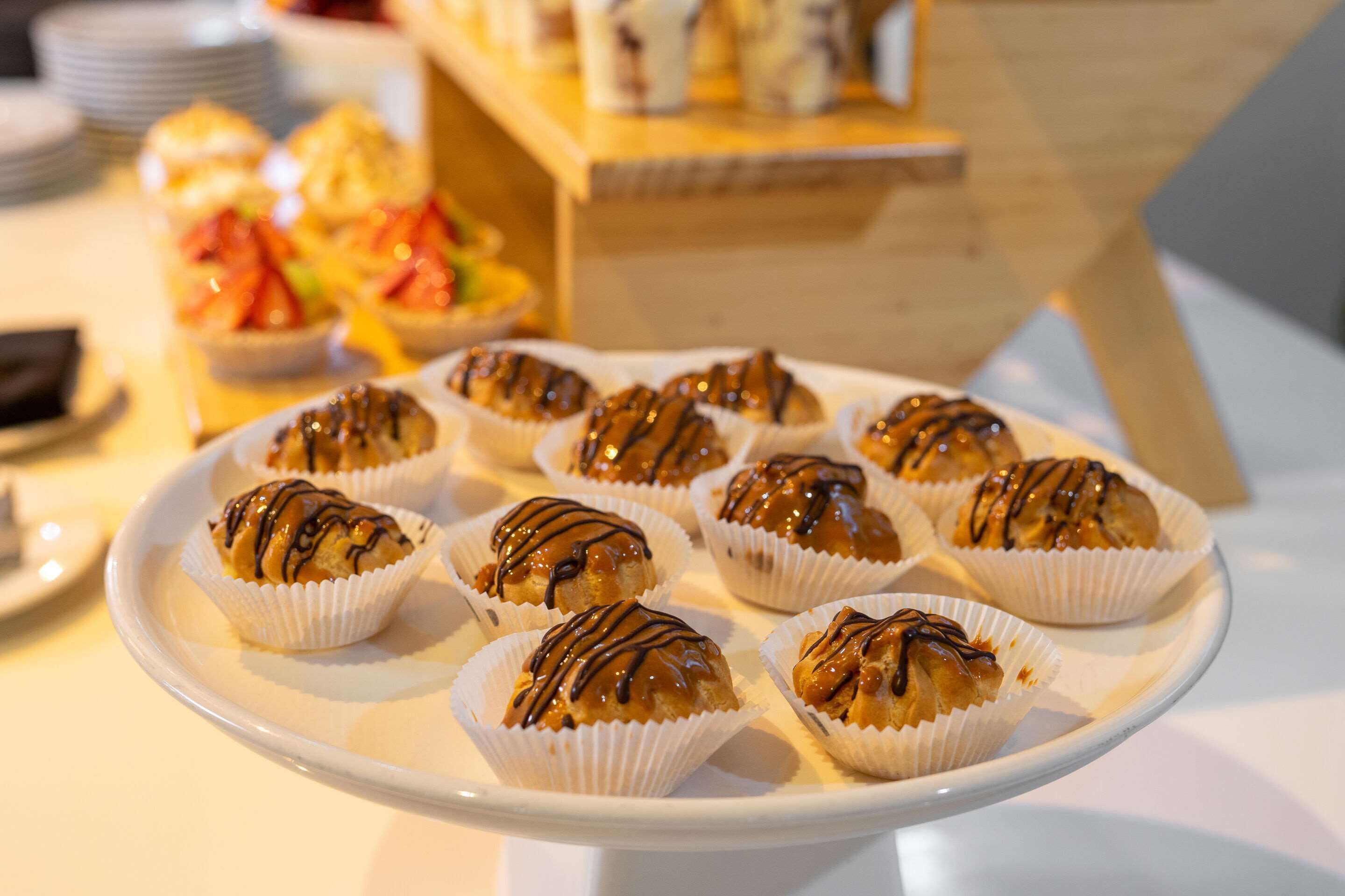 A plate of pastries with chocolate drizzle.