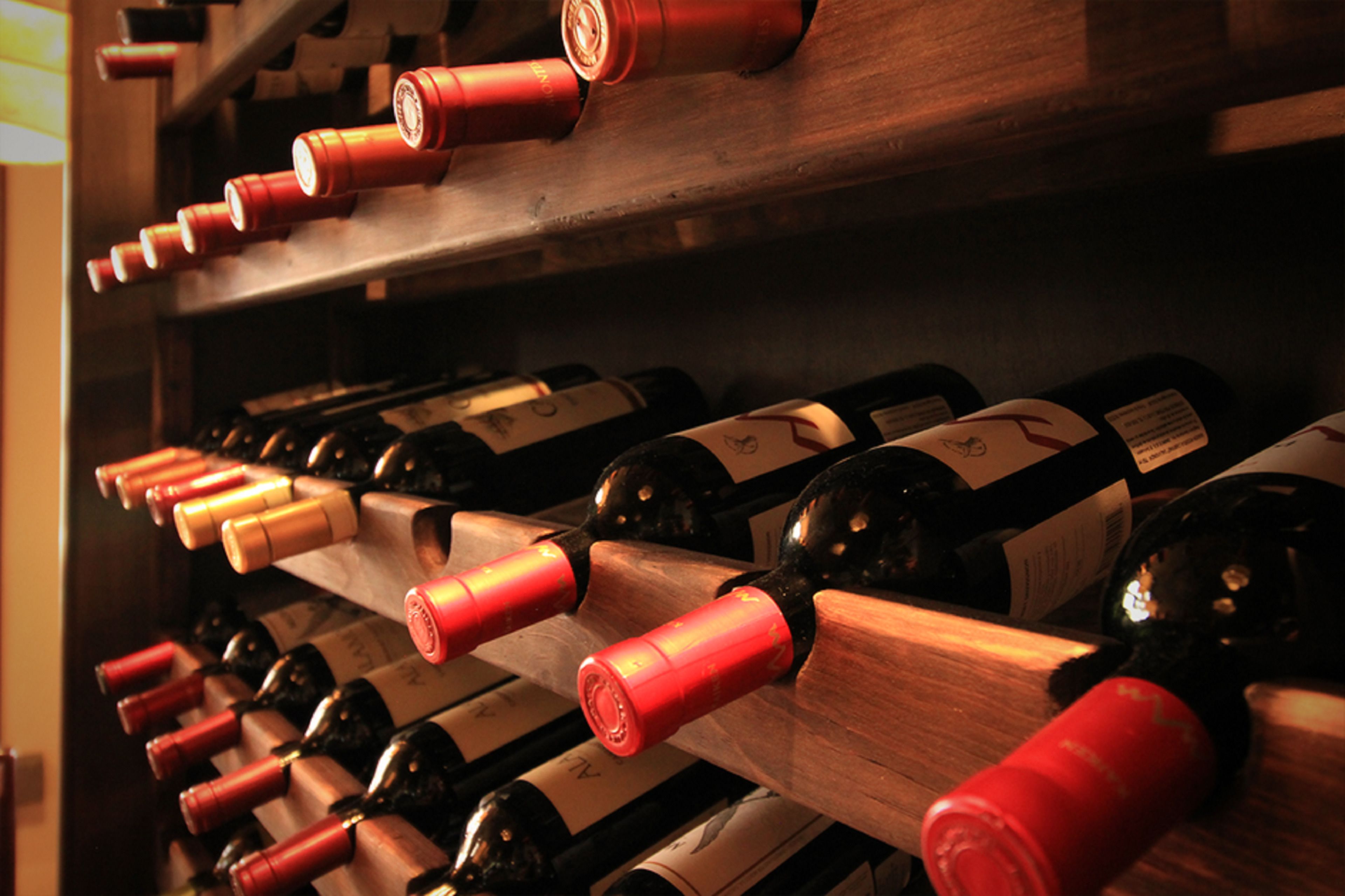 A wine rack with multiple bottles of wine.