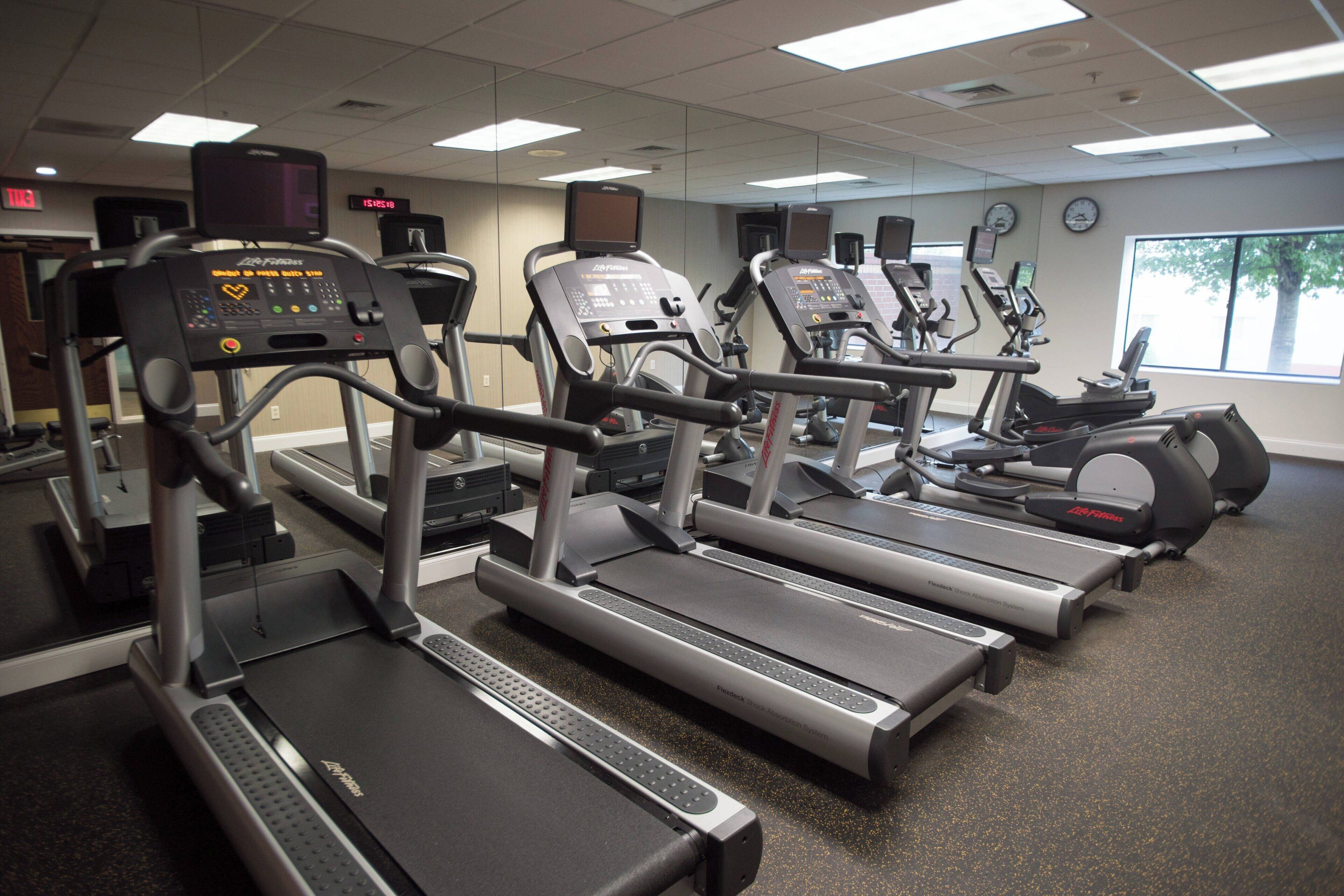 A gym with treadmills, ellipticals, and stationary bikes.