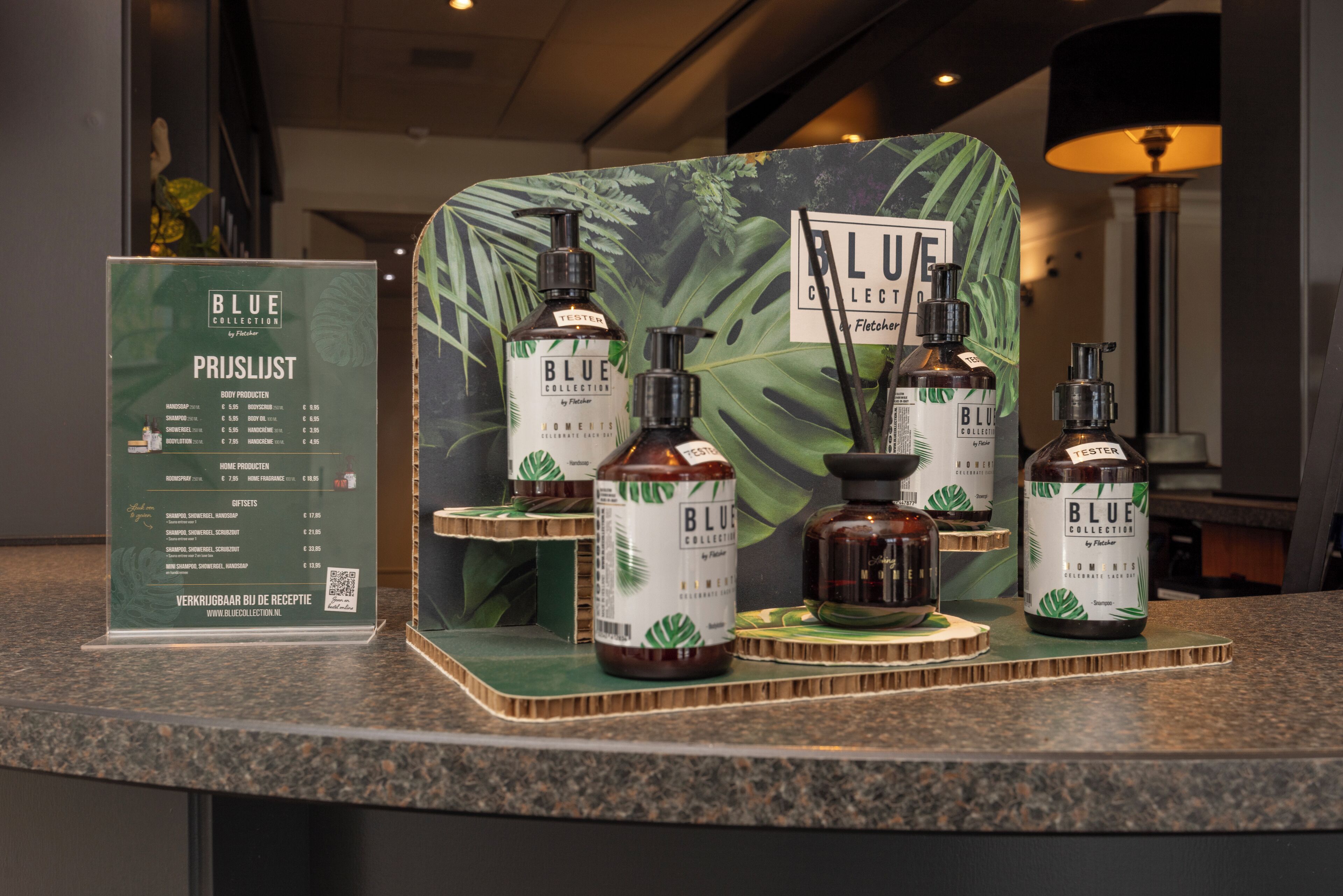 A display of Blue Collection body products at a hotel reception.