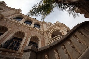 A historic building with ornate arches and a stone staircase. - Jacir Palace Hotel Bethlehem (Bethlehem)