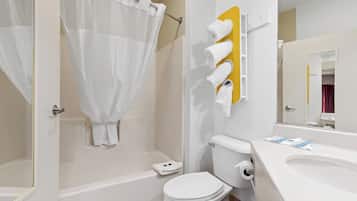 A bathroom with a bathtub, toilet, and sink.