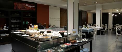 A buffet area with various food items and a glass display case.