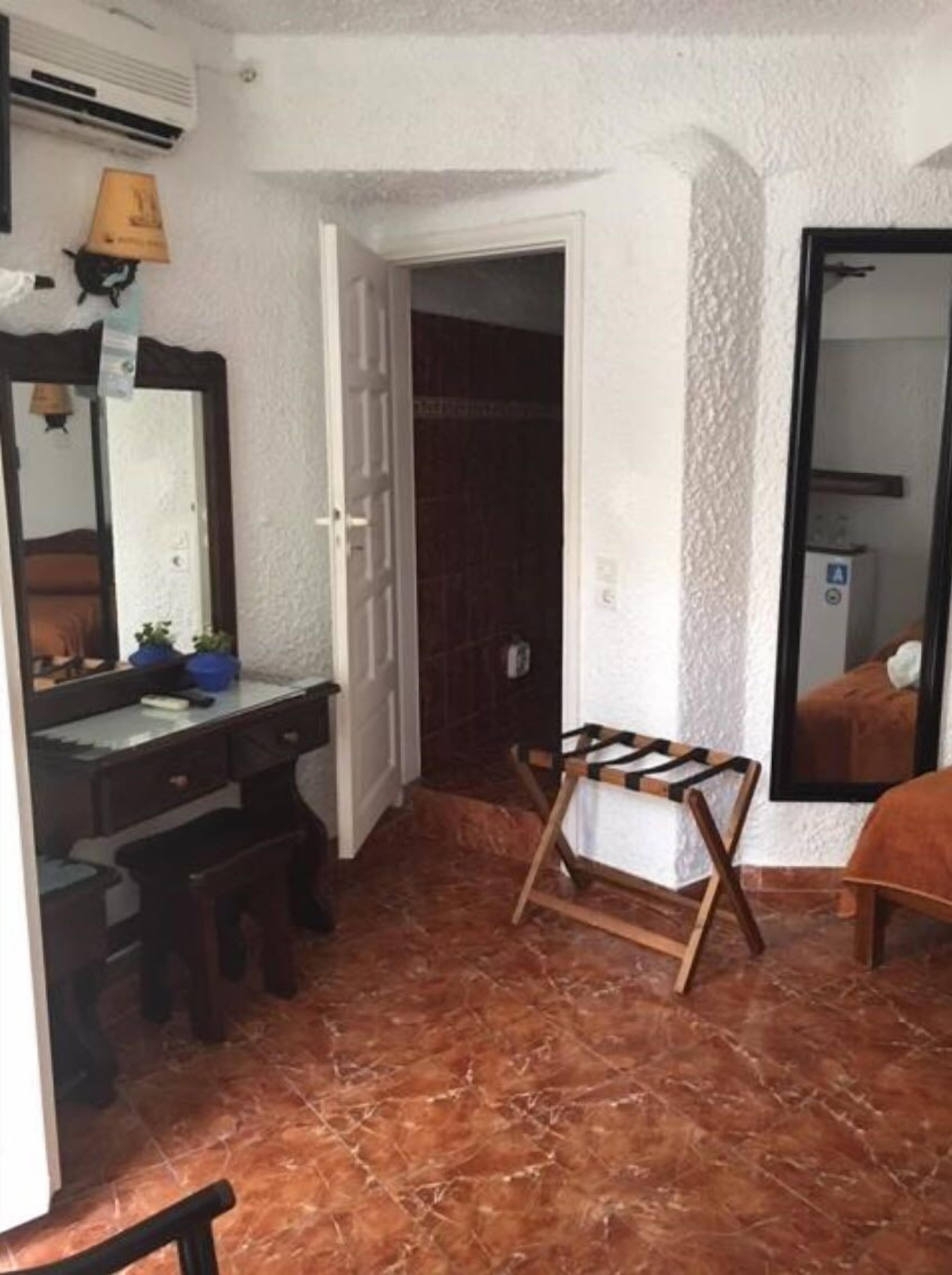 economy double or twin room (semi-basement) | living area | 21-inch flat-screen tv with satellite channels, tv