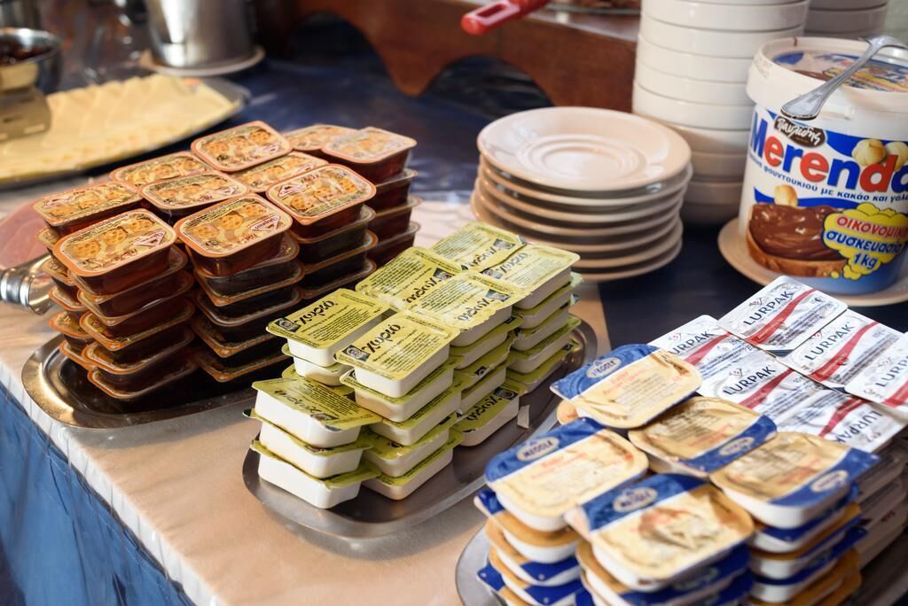A buffet with various food items including jars of preserves and packaged foods.
