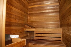 A sauna with wooden walls and benches. - Happy Day Inn (Burnaby)