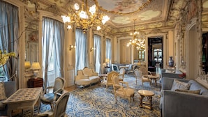 A luxurious room with ornate chandeliers, elegant furniture, and a patterned carpet. -  Pestana Palace Lisboa Hotel & National Monument - The Leading Hotels of the World (Lisbon)