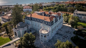 A large, historic building with a central courtyard and a dome. -  Pestana Palace Lisboa Hotel & National Monument - The Leading Hotels of the World (Lisbon)