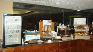 A breakfast bar with a refrigerator displaying fresh ingredients, a cereal dispenser, and a sign for 'Express Start' breakfast.