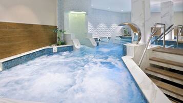 Enjoy a refreshing swim in our pool, surrounded by a decorative wall and stairs leading to a higher level.