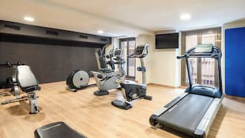 A gym with treadmills, stationary bikes, and weight machines.