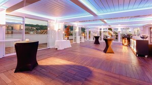 A spacious rooftop terrace with wooden flooring, glass walls, and a modern ceiling design. - Abba Euskalduna Hotel (Bilbao)