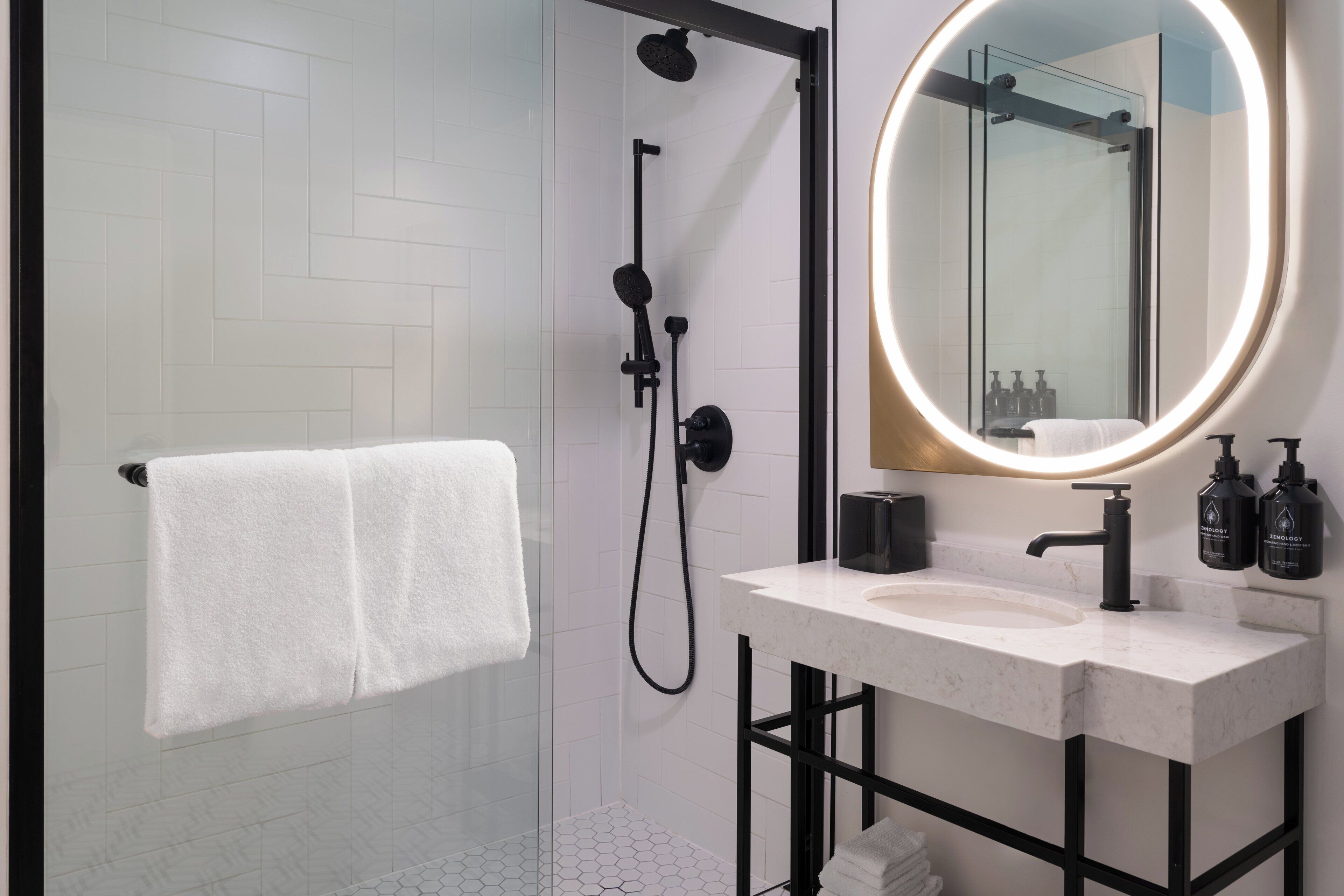 spring water bathtub, designer toiletries, hair dryer, towels