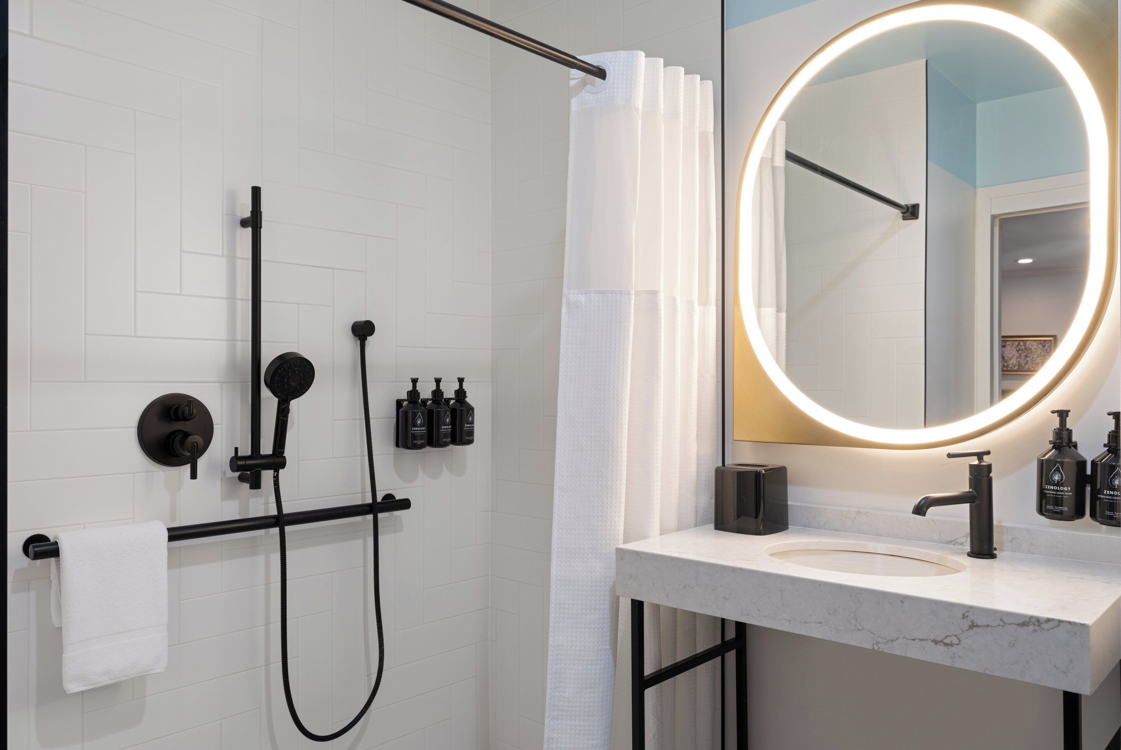 spring water bathtub, designer toiletries, hair dryer, towels