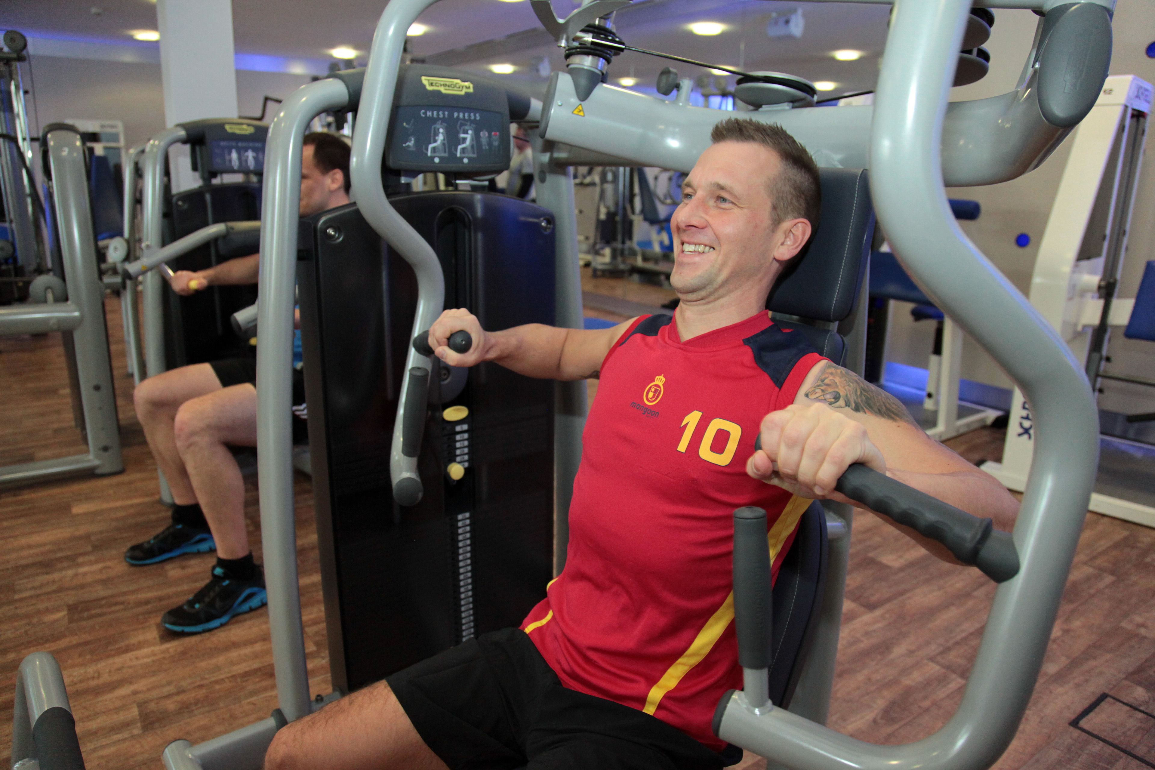 A gym with exercise equipment, including a chest press machine.