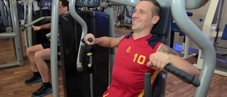 A gym with exercise equipment, including a chest press machine.