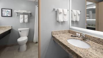 A bathroom with a toilet, sink, and towel rack.
