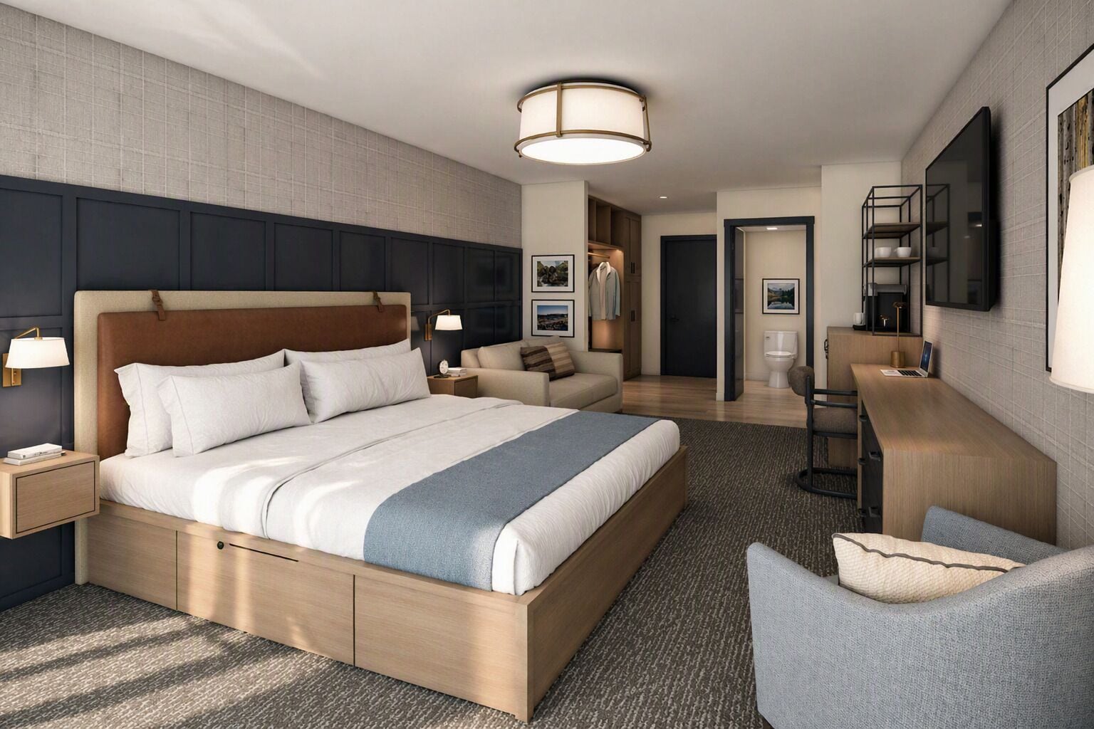 Une chambre d’hôtel moderne équipée d’un grand lit, d’un bureau, d’une chaise et d’une salle de bain séparée.