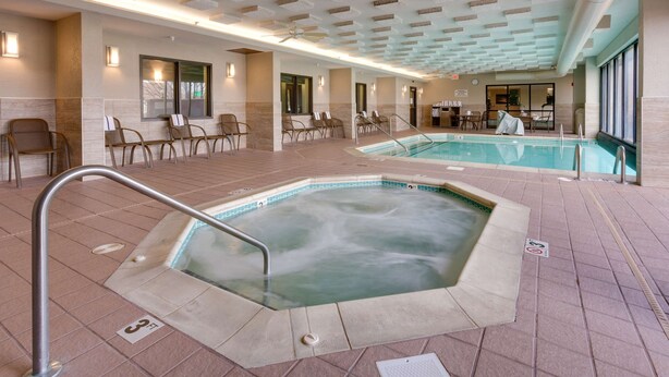 A hotel lobby with a large indoor pool, seating areas, and a reception desk. - Drury Inn & Suites Kansas City Overland Park (Overland Park)
