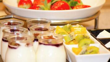 A dessert buffet with various fruit and yogurt parfaits.