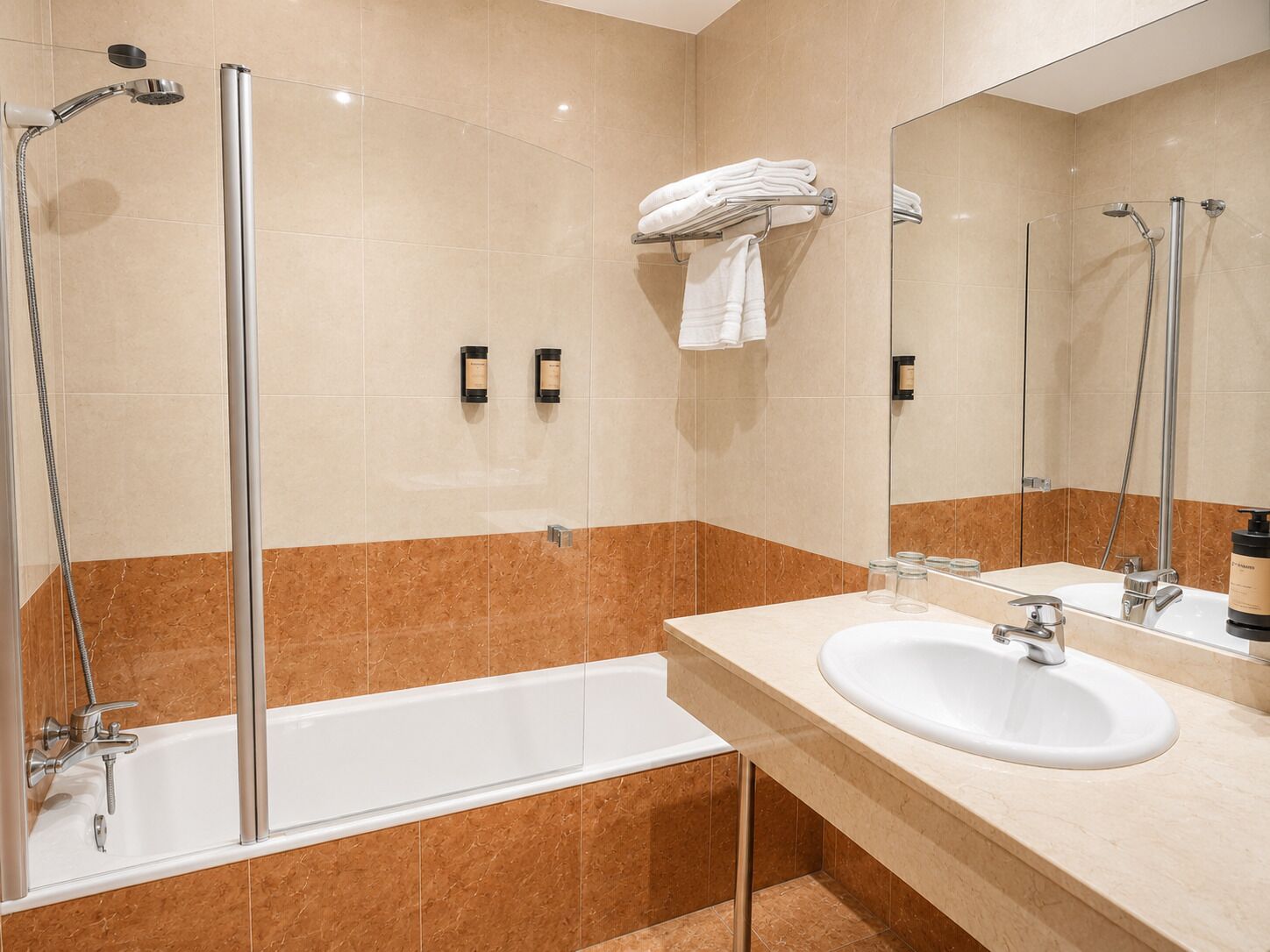 A modern bathroom with a glass-enclosed shower, a bathtub, a sink, and a mirror.