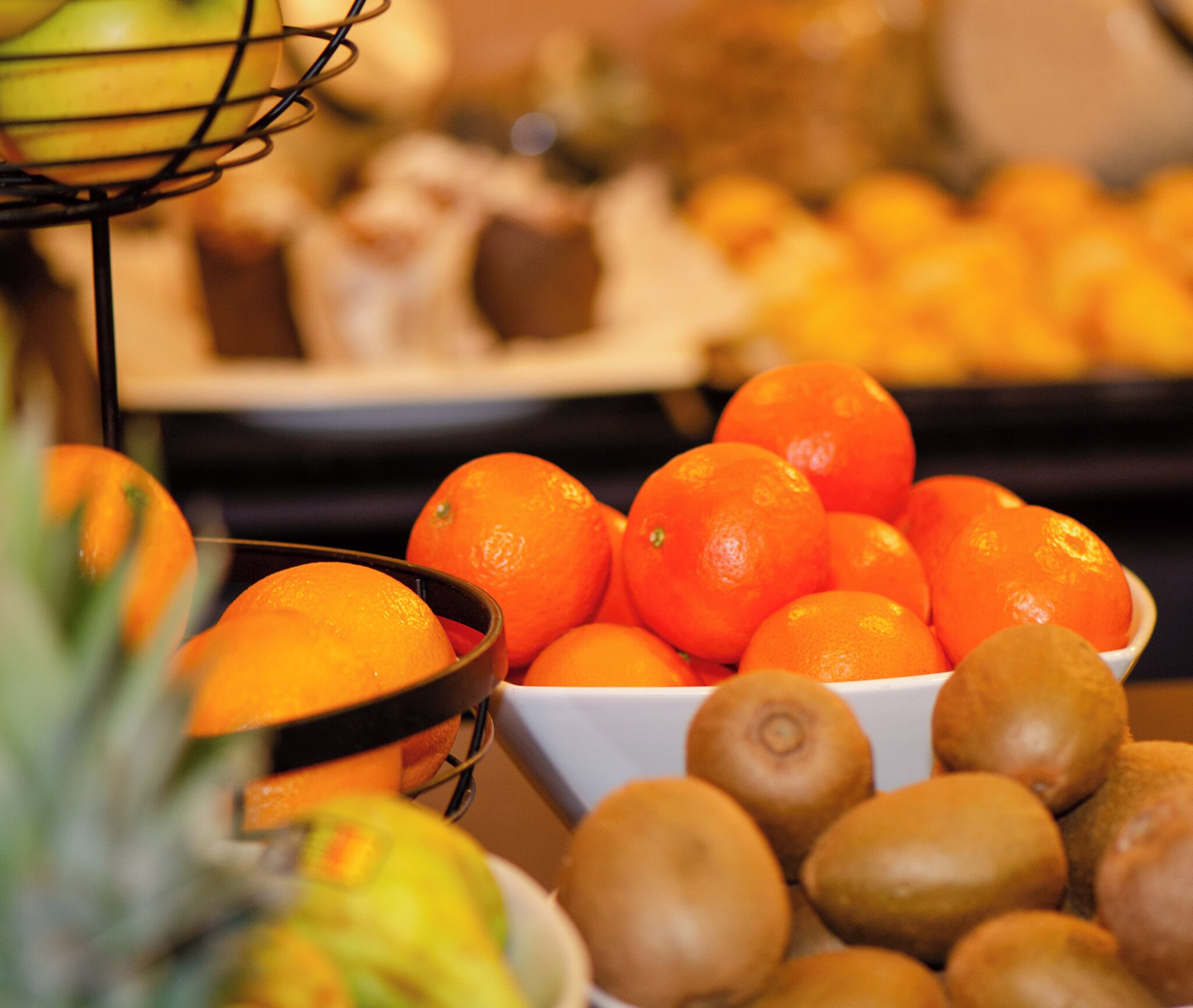A fruit display with oranges and kiwis.
