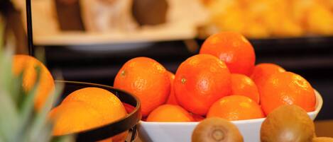 A fruit display with oranges and kiwis.