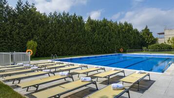 Seasonal outdoor pool, pool loungers