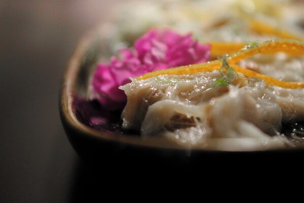 A close-up of a dish with meat and vegetables. - Gran Hotel Barcino (Barcelona)