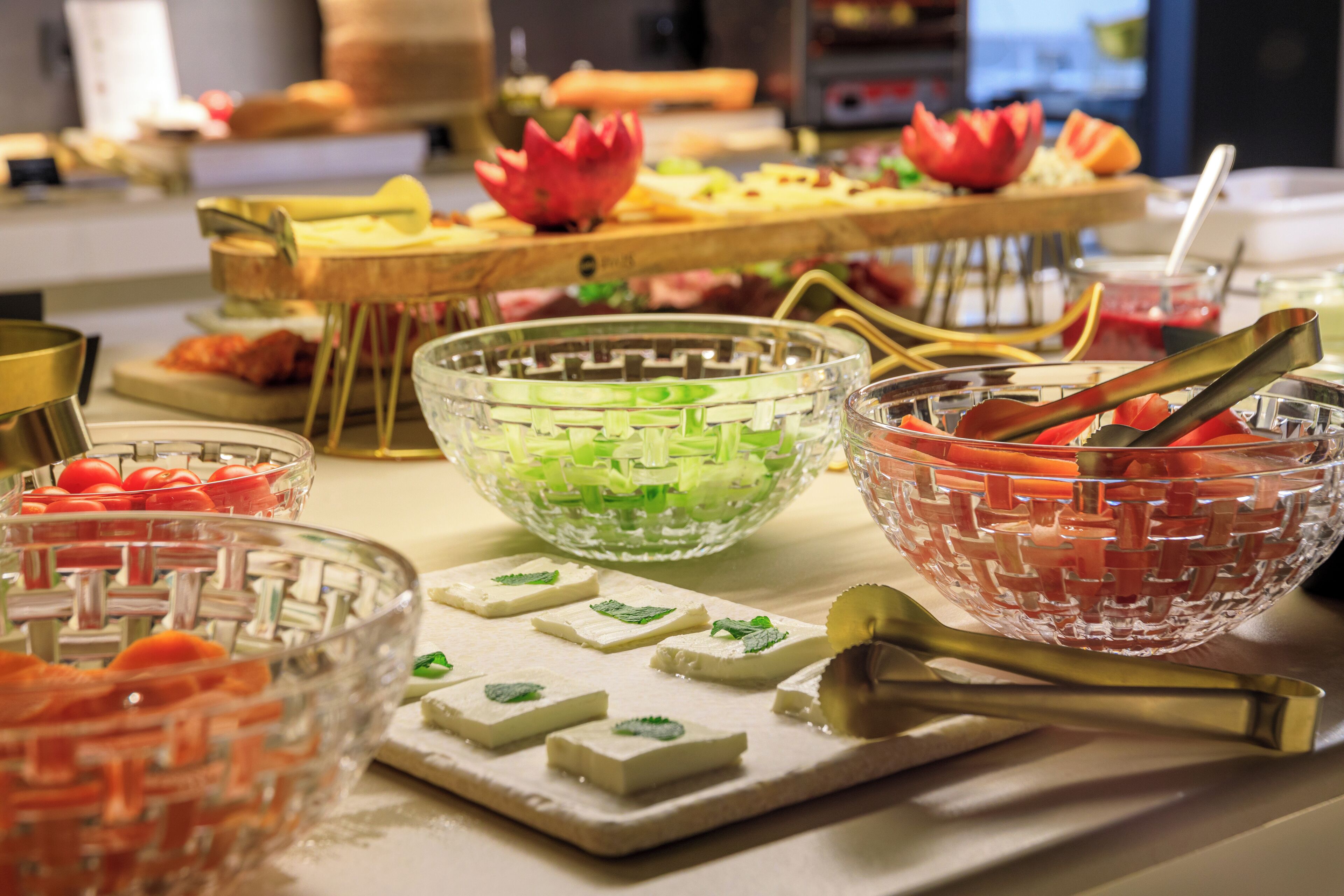 A buffet table with various food items and decorative elements.