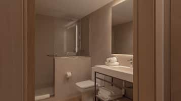 A modern bathroom with a shower, toilet, and sink.