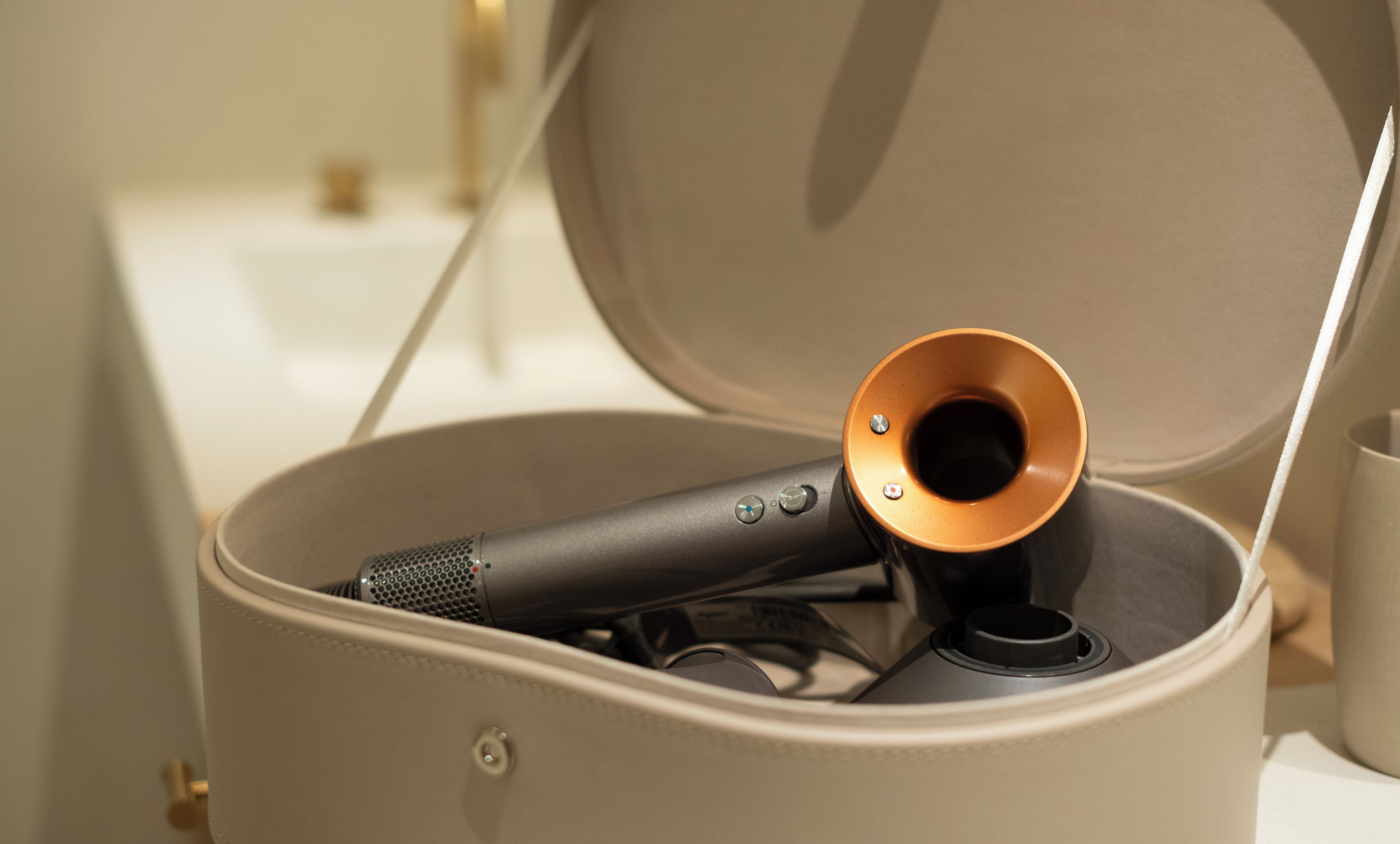 A beige suitcase with a microphone and a small speaker inside.