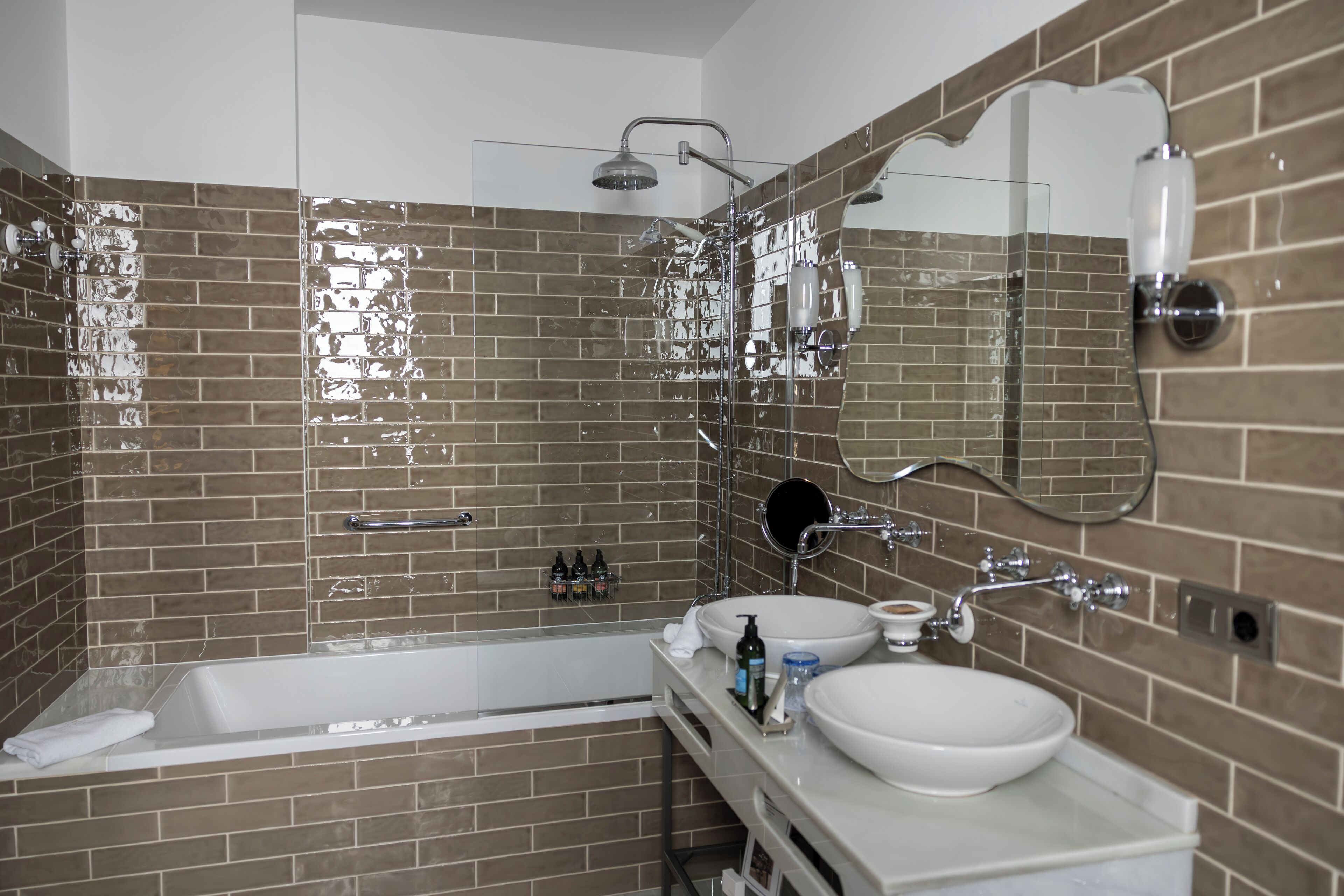 A modern bathroom with a bathtub, a sink, and a shower.
