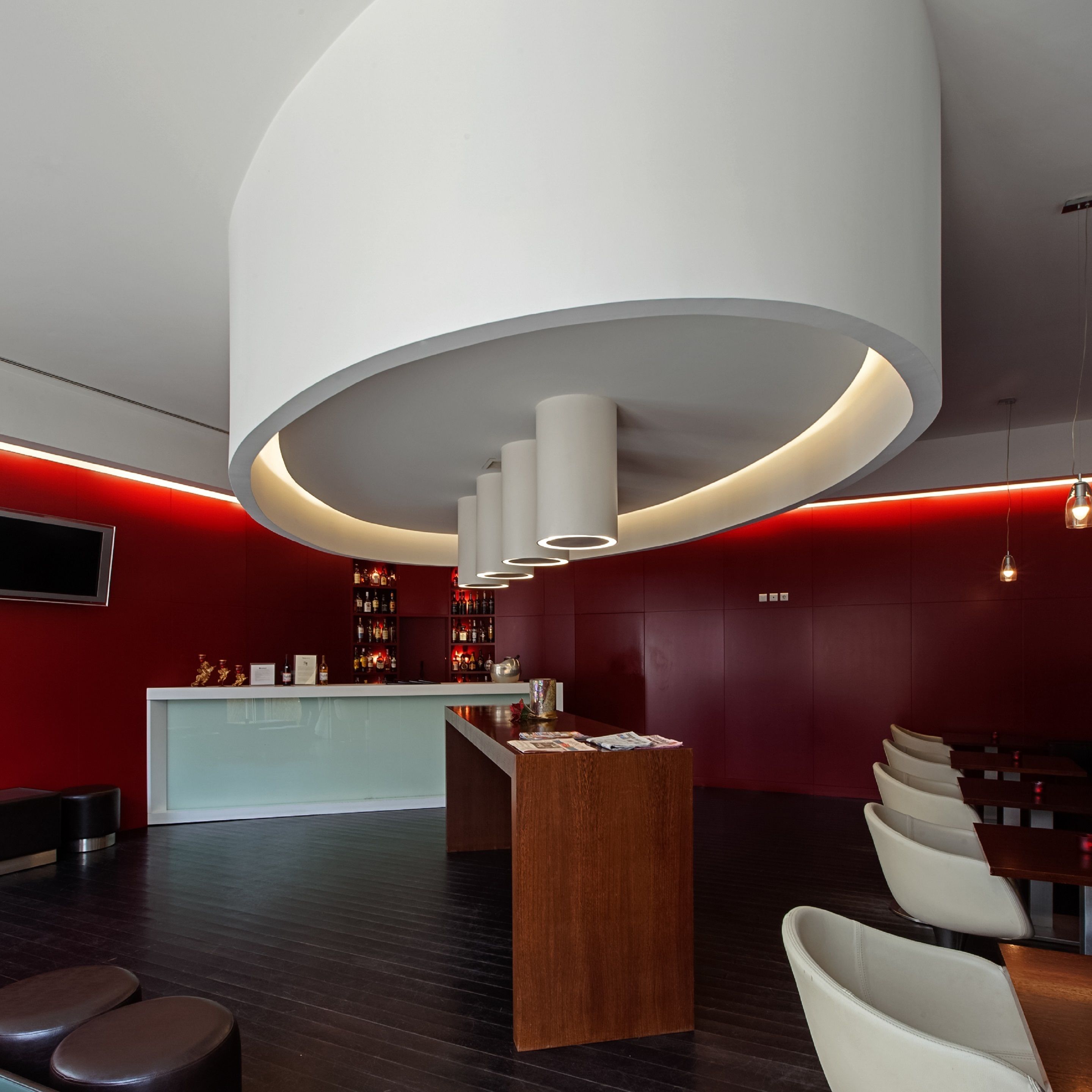 Un moderno vestíbulo de hotel con mostrador de recepción, zona de estar y bar.