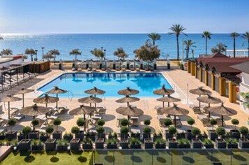 Piscine extérieure, parasols de plage, chaises longues