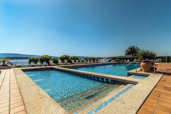 Indoor pool, seasonal outdoor pool, pool umbrellas, sun loungers