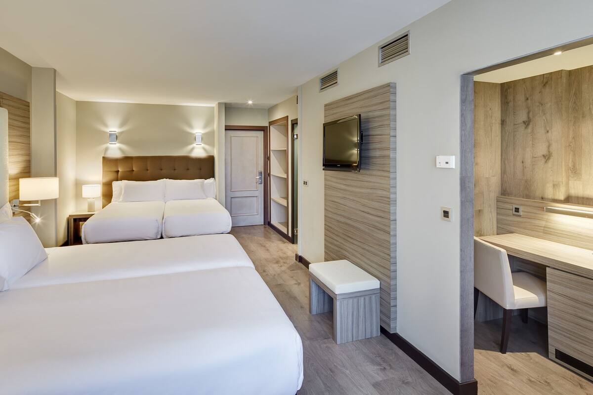 family room | 1 bedroom, minibar, in-room safe, desk