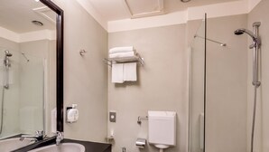 A modern bathroom with a double sink, toilet, bidet, and a glass-enclosed shower area. - Best Western Plus CHC Florence (Florence)