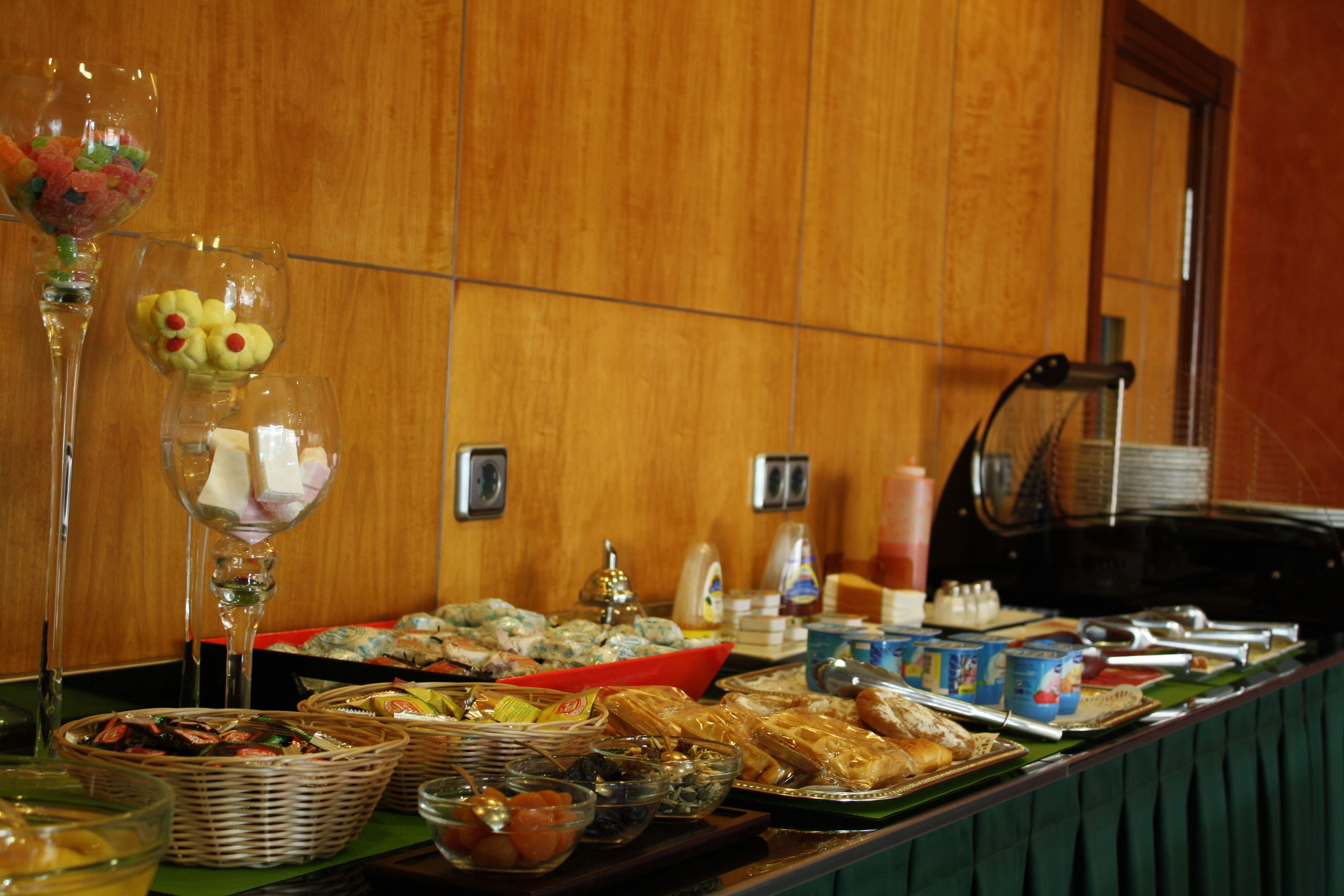 A buffet table with various food items and beverages.