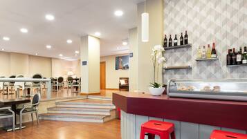 Un restaurante moderno con área de bar, arreglos de asientos y una exhibición de vinos.