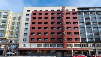 A multi-story hotel with a prominent red facade and a sign reading "HOTEL RIOSOL".