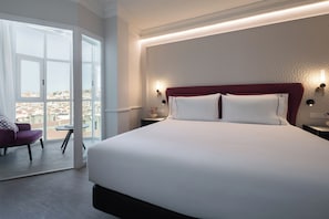 Junior Suite, City View | Minibar, in-room safe, soundproofing, iron/ironing board